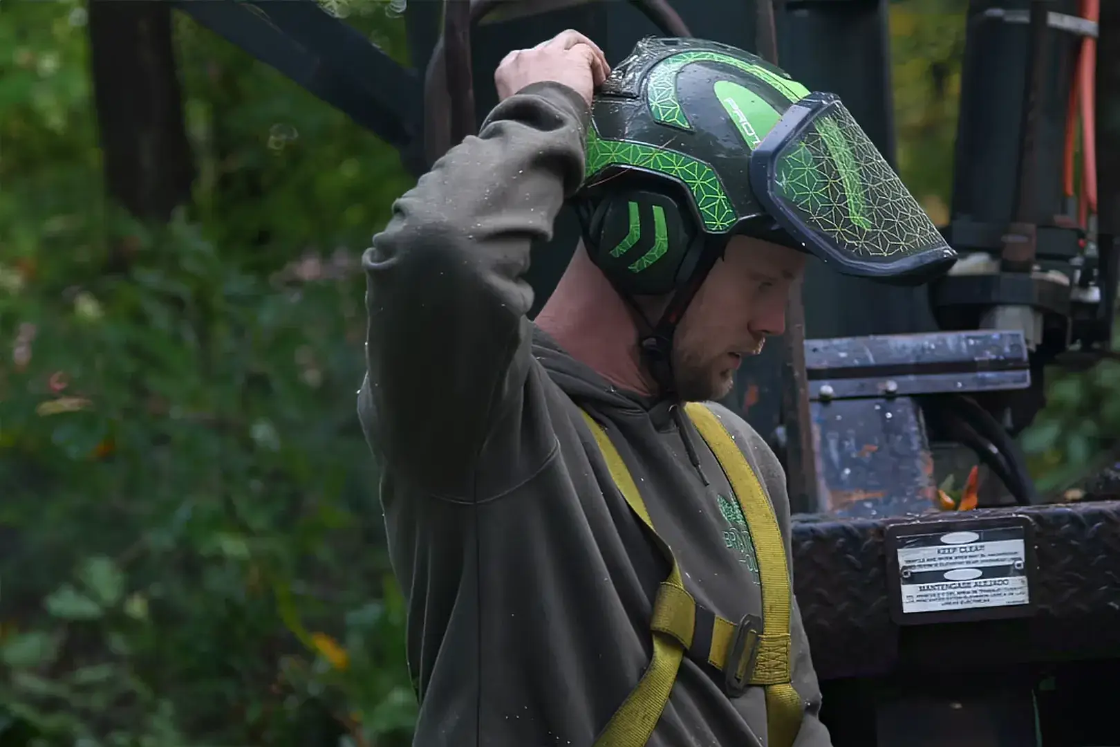 Cory Higgins, owner of Branched Out LLC tree service in New London County, CT, putting on his climbing helmet